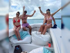 A lively group enjoys a fun day on the water, celebrating and relaxing on a boat — perfect for summer outings and memorable adventures.