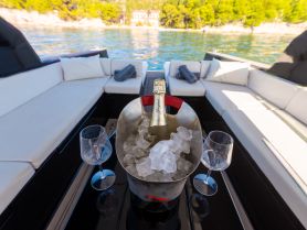 A stylish setup featuring a chilled bottle of champagne in an ice bucket, perfect for enjoying luxurious moments on the water.