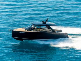 A sleek speedboat glides through clear blue waters, showcasing its modern design and performance on the open sea.