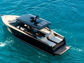 A stunning aerial view of a sleek yacht cruising through crystal-clear waters, showcasing its modern design and luxurious features.