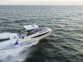 An elegant speedboat glides through the water, showcasing its sleek design and powerful performance — perfect for thrilling adventures on the open sea.