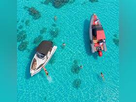 A vibrant scene of people enjoying the crystal-clear waters, with two boats nearby — perfect for a fun day of swimming and relaxation under the sun.