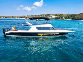 A sleek yacht docked in clear turquoise waters, showcasing its elegant design and perfect for luxury charters or day trips.
