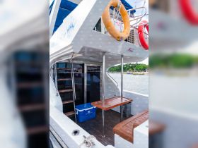 Interior view of a boat showcasing the seating area and helm, perfect for relaxing and enjoying the journey on the water.