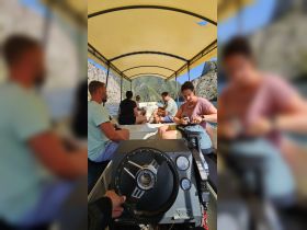 Inside view of a boat's helm area with guests seated, showcasing a relaxed atmosphere during a scenic outing.
