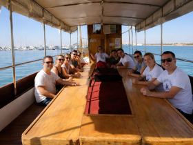 A group of friends enjoys a relaxing moment inside the cabin of a boat, showcasing the spacious seating area perfect for social gatherings on the water.