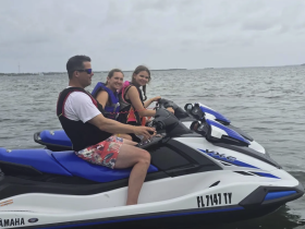 A fun group enjoys a thrilling ride on jet skis, capturing the excitement of water sports and adventure on the open water.