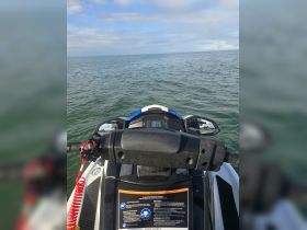 A close-up view of a jet ski's handlebars and safety instructions, showcasing the thrill of water sports and the importance of rider safety on the water.