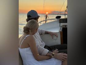A couple enjoys a romantic sunset aboard a yacht, creating a perfect backdrop for special moments and celebrations on the water.