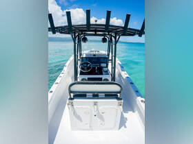 A clear view of the helm and seating area inside a boat, showcasing the modern console and controls, perfect for navigating the open waters.