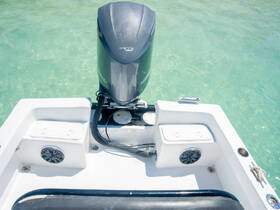 A detailed view of the helm area on a boat, showcasing the console and surrounding features, perfect for those interested in boat interiors and equipment.