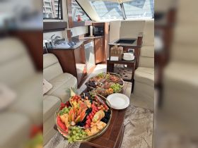 A beautifully arranged fruit platter and snacks set up inside a boat, perfect for catering during a luxurious cruise or gathering on the water.