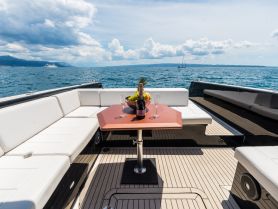 A beautifully arranged table on a boat featuring champagne and fresh fruit, perfect for a luxurious day on the water.