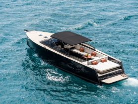 A stunning aerial view of a sleek yacht cruising through clear turquoise waters, showcasing its elegant design and spacious seating area.