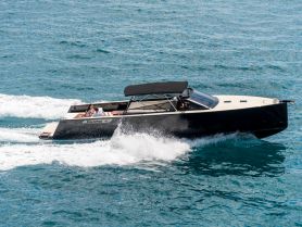 A stylish speedboat cuts through the waves with a couple enjoying the ride, showcasing the thrill of a day on the water.