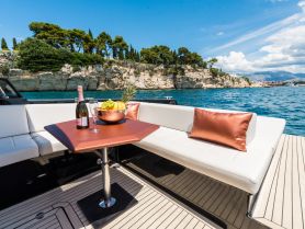 A beautifully arranged table on a boat featuring champagne and fresh fruit, perfect for a luxurious day on the water.