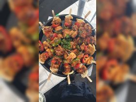 A vibrant platter of grilled chicken and vegetable skewers, perfect for onboard dining or catering during a boat trip.