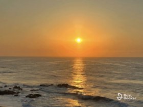 A stunning sunset over the ocean, casting golden reflections on the water — a perfect backdrop for evening boat cruises or romantic getaways.