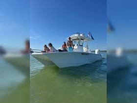 A lively group enjoys a sunny day on a boat, showcasing the perfect atmosphere for fun and relaxation on the water.