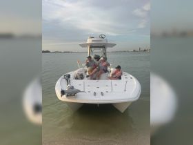 A family enjoys drinks on a pontoon boat, creating memorable moments on the water — perfect for sunset cruises and family outings.