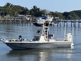 A group of friends enjoys a day of fishing on a boat, showcasing the fun and camaraderie of a family outing on the water.