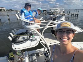 A joyful family enjoys a fishing trip on a boat, with kids in life jackets and smiles all around — perfect for creating lasting memories on the water.