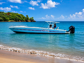 A sleek speedboat named 'Infinity' is docked in clear turquoise waters, showcasing its vibrant design against a picturesque coastal backdrop.