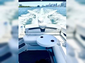 A sleek interior view of a boat's helm and seating area, showcasing modern design and comfort, perfect for a day on the water.