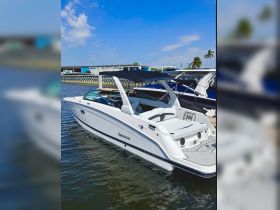 A sleek Aquamarine yacht docked at the marina, showcasing its elegant design and spacious seating — perfect for luxury outings on the water.