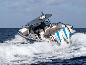 A dynamic shot of a speedboat cutting through the waves, showcasing its sleek design and performance on the open water.