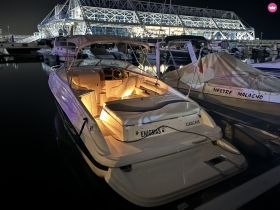 A beautifully lit yacht docked at night in Cascais, showcasing its elegant design against the marina backdrop.