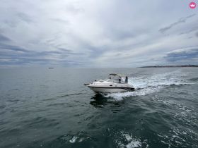 A speedboat glides through calm waters, showcasing an exciting day on the water with guests enjoying the ride.