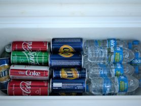 A well-stocked cooler filled with a variety of drinks, including sodas and bottled water, perfect for keeping guests refreshed during a day on the water.