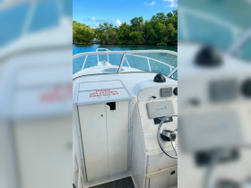 A view of the helm and console area inside a boat, showcasing essential safety equipment and navigation tools, perfect for a day on the water.