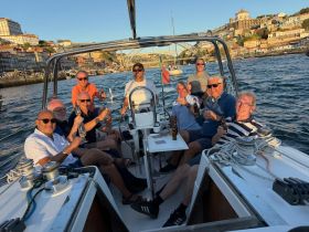 A lively group of friends enjoys drinks and celebration aboard a boat, surrounded by scenic views — perfect for memorable gatherings on the water.