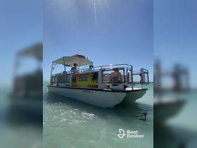 A lively scene aboard a boat offering Upper Keys cruises and tours, showcasing guests enjoying the sunny day on the water.