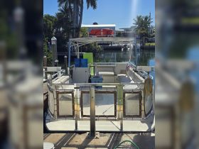Interior view of a pontoon boat showcasing its seating and cabin area, perfect for relaxing and enjoying time on the water.
