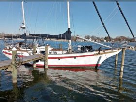 A beautiful sailboat docked at the pier, showcasing its elegant design and serene surroundings — perfect for sailing enthusiasts.