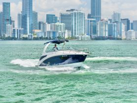 A sleek speedboat navigates the vibrant waters of Miami, with a stunning city skyline in the background — perfect for thrilling adventures on the water.
