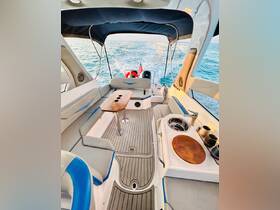 An inviting interior view of a boat's helm and seating area, showcasing comfortable seating and amenities, perfect for a day out on the water.