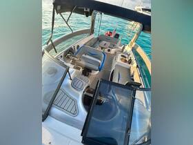 An inviting view of the interior helm and seating area of a boat, showcasing comfortable seating and a well-designed layout, perfect for a day on the water.