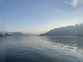A serene view of a tranquil lake at sunset, framed by majestic mountains — perfect for nature lovers and peaceful getaways.