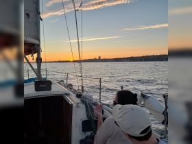 Guests enjoy a beautiful sunset while sailing, creating a perfect backdrop for memorable moments on the water.