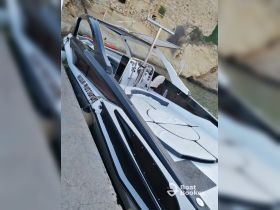 A sleek speedboat docked at the harbor, showcasing its modern design and spacious seating area, perfect for day trips on the water.