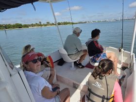 A family enjoys a relaxing fishing trip on a boat, taking in the scenic views and quality time together on the water.