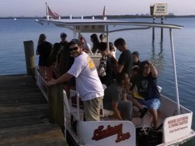 A lively group boards the 'Lindsay Lee' boat for an inshore sightseeing and fishing charter, ready for an exciting day on the water.