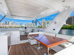 A beautifully designed interior of a yacht featuring a spacious seating area and helm, perfect for enjoying luxurious cruising experiences.