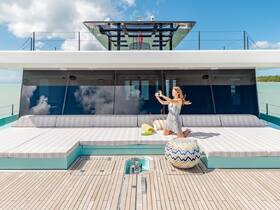 A woman captures a selfie on the spacious deck of a luxury yacht, showcasing the perfect setting for memorable moments on the water.