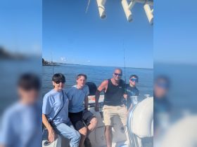 A family enjoys a day of fishing on a boat, capturing the joy of togetherness and outdoor adventure on the water.