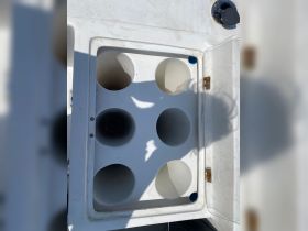 A close-up view of a boat cooler, showcasing multiple compartments for drinks — perfect for keeping refreshments cool during your boating adventures.